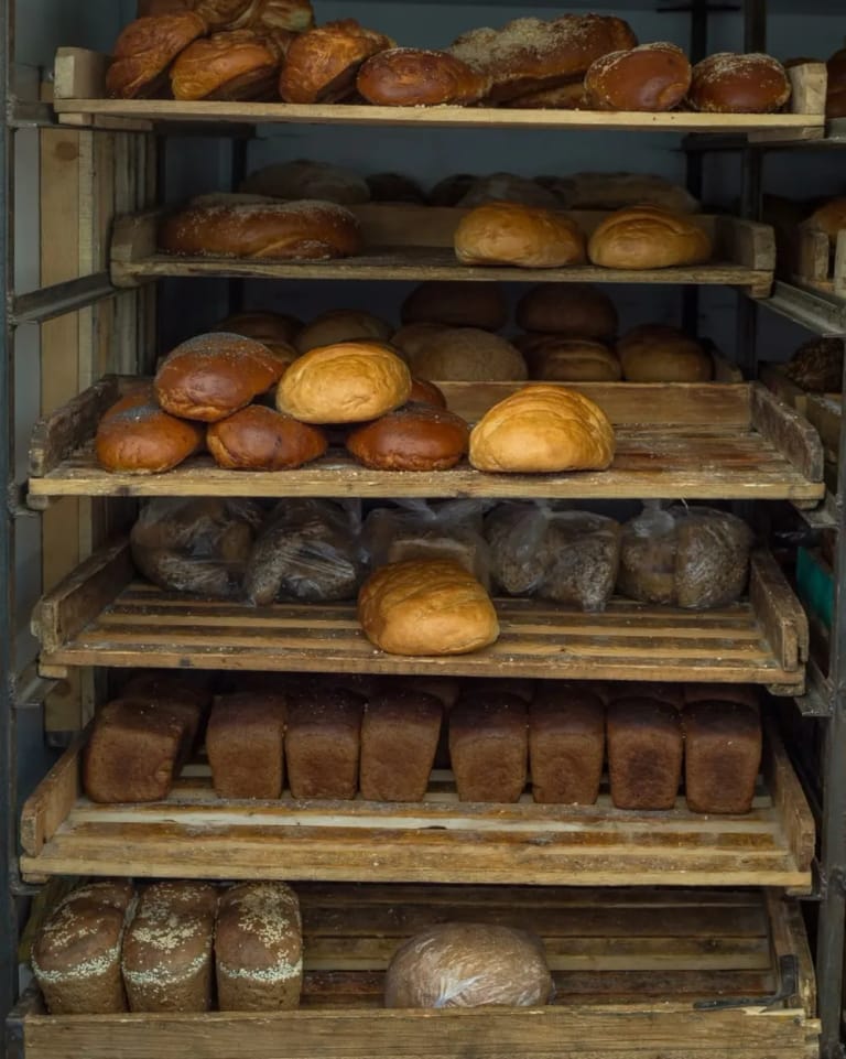 Bakery racks of fresh bread and buns