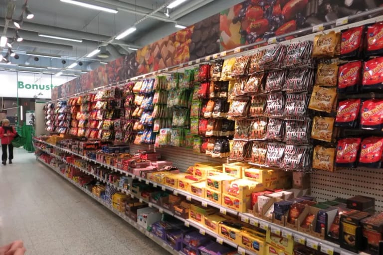 Supermarket aisle with packaged food on the shelves